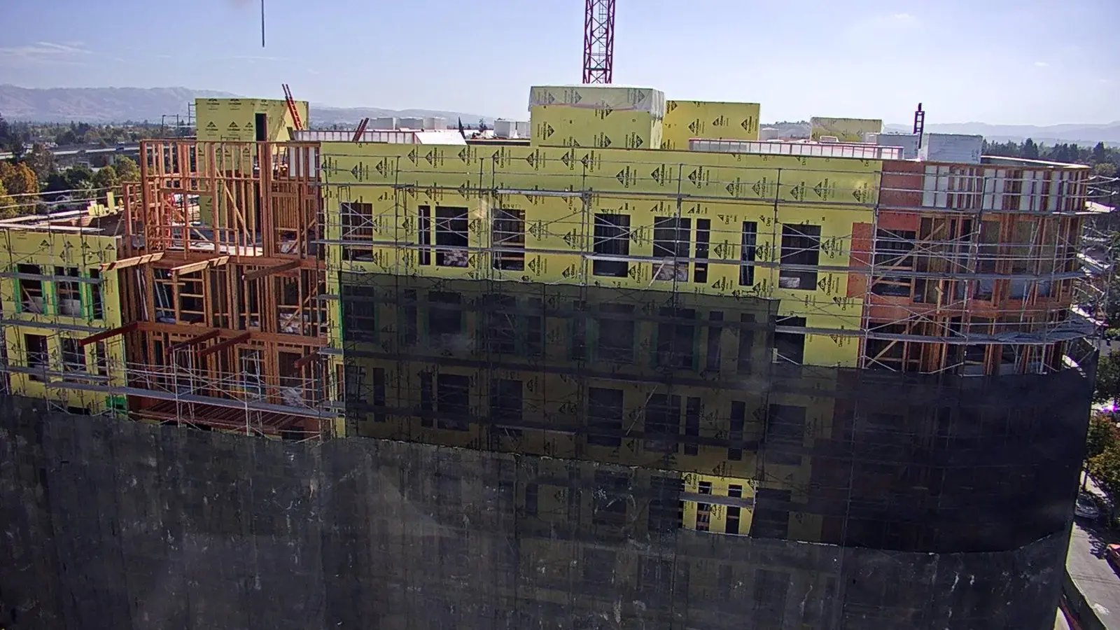 Actual construction photograph of Aquino showing framing, sheathing and scaffolding