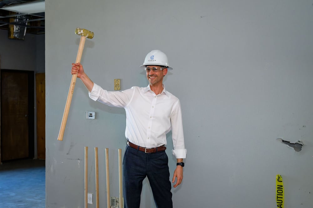 Groundbreaking participant holding a ceremonial mallet
