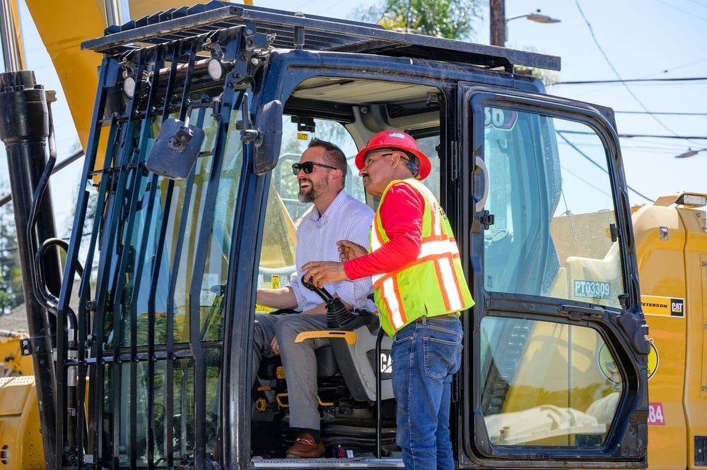 Groundbreaking participant inside an excavator
