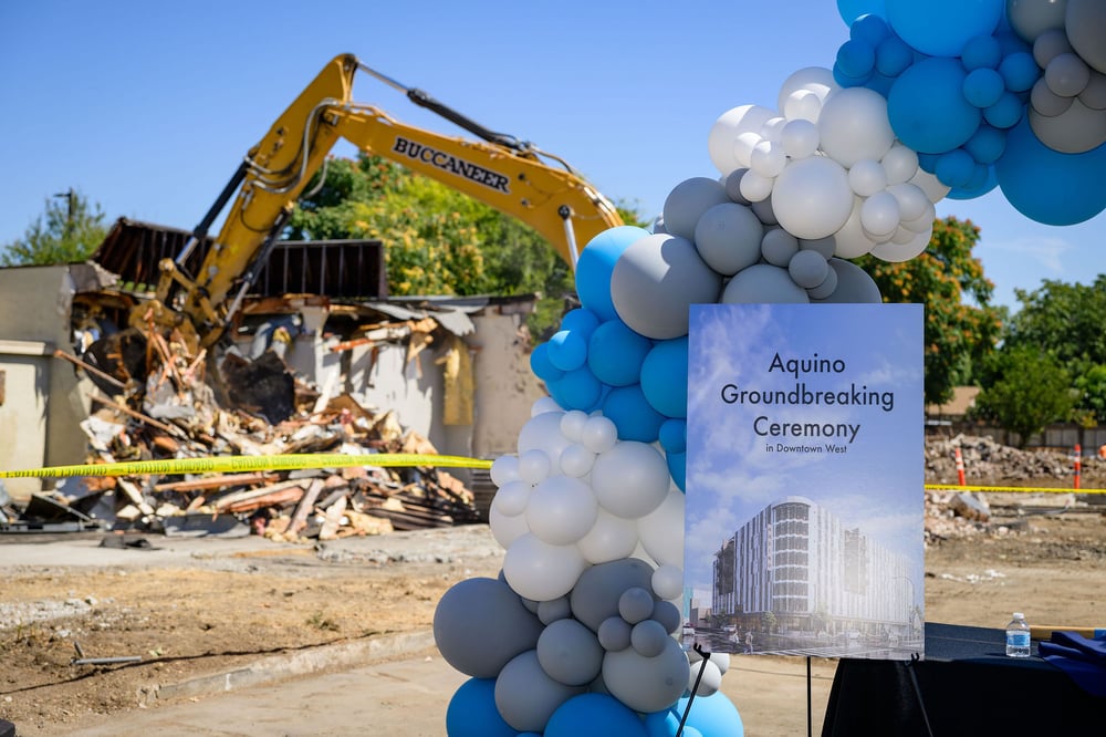 Aquino groundbreaking display beside active demolition at the project site