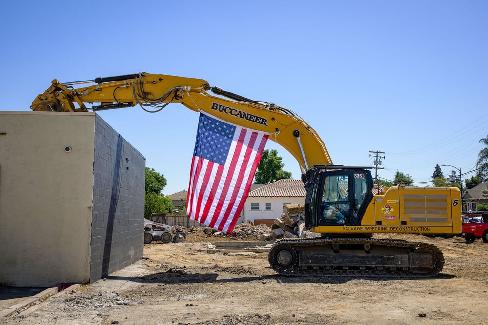 Excavator and American flag at the Aquino site