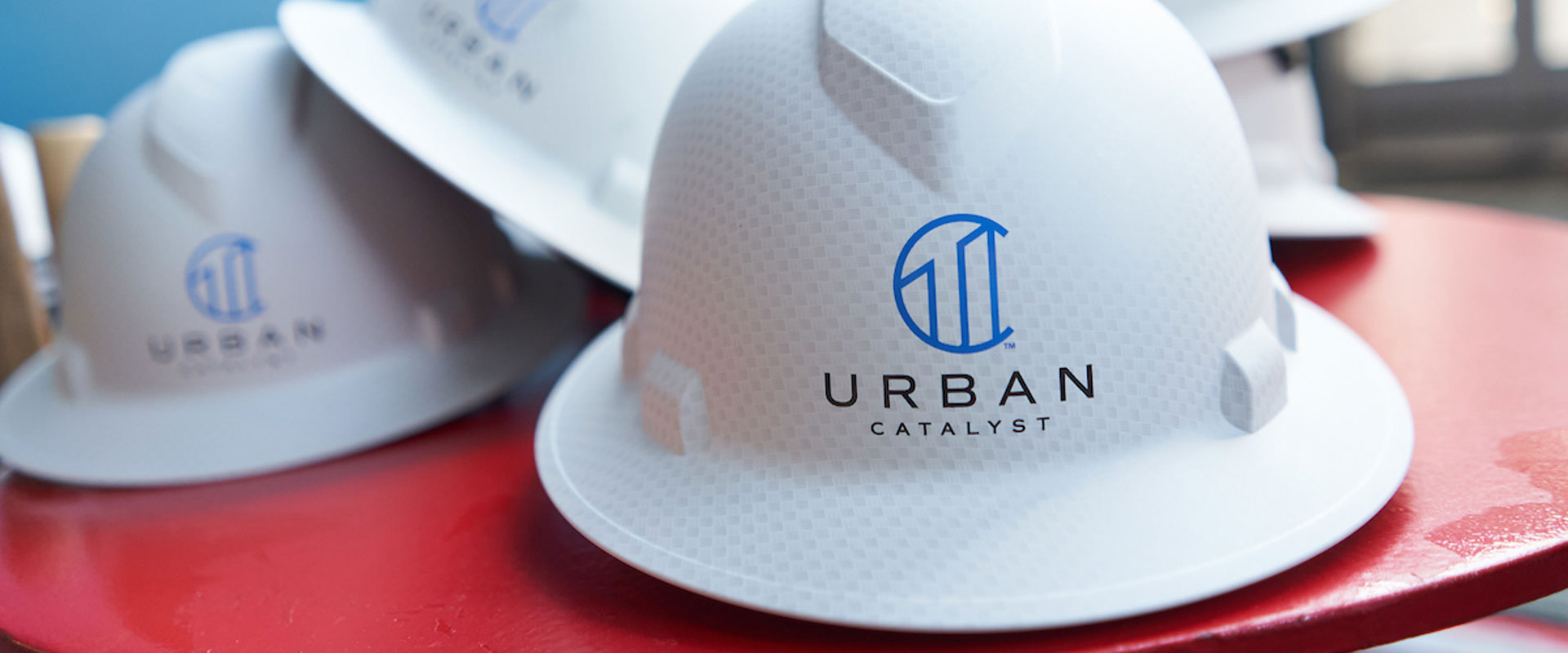 Urban Catalyst branded hard hats at a San Jose groundbreaking event